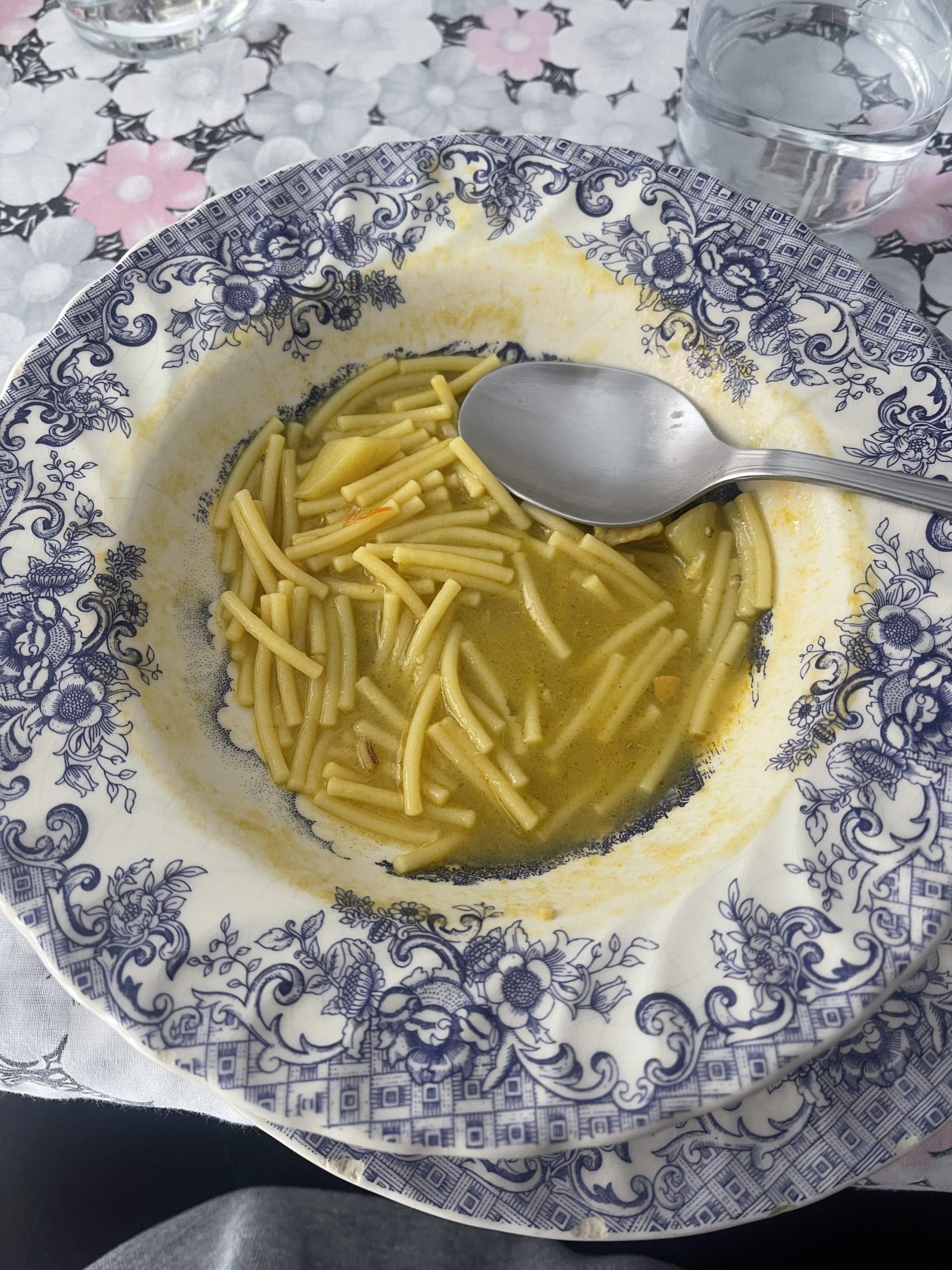 A photo of a bowl of soup on a table.