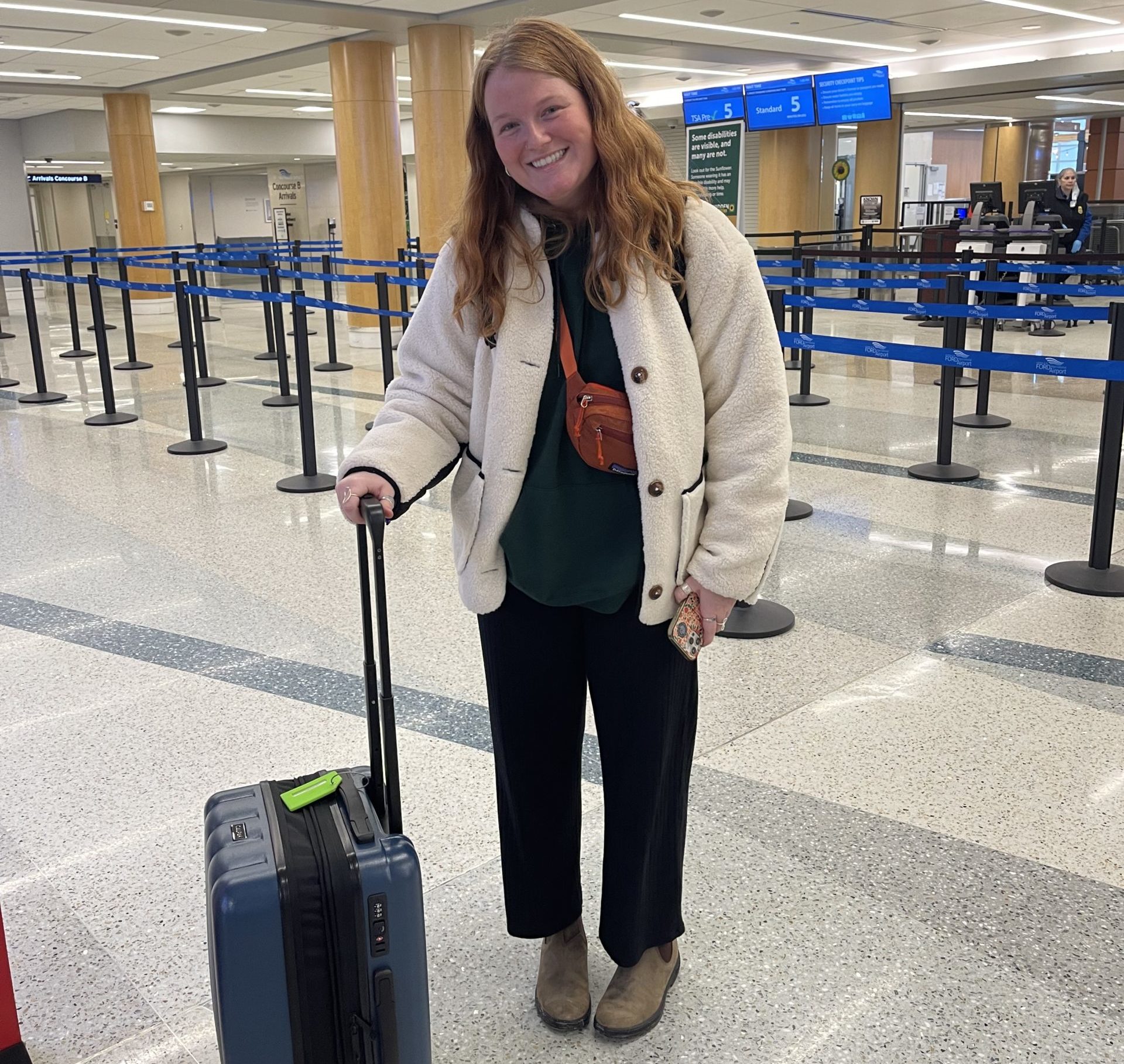 Me in the airport with my luggage ready to go through security and board my first flight!